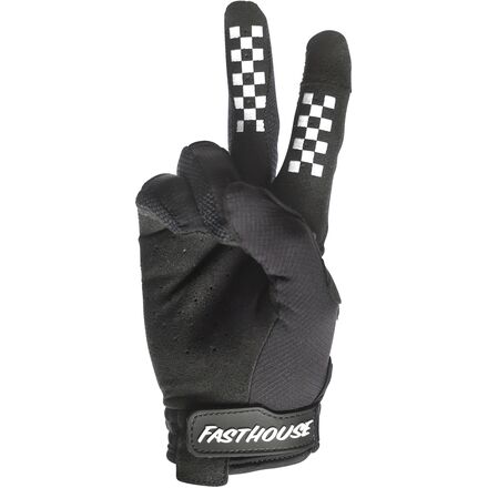 Black glove with checkered pattern on fingers and 'Fasthouse' branding on a white background